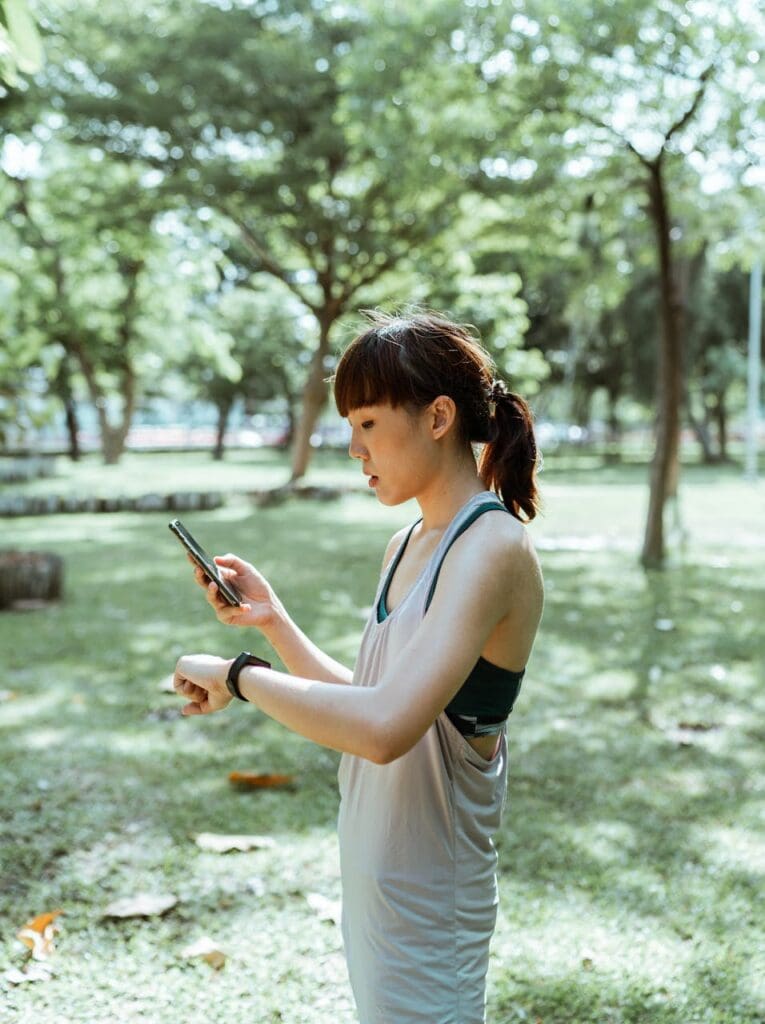 A Woman Using Habit Tracking Apps To Log The Progress Of Her Running On Her Phone.