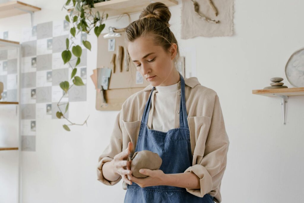 Hobbies to start in your 20s: A woman working with clay