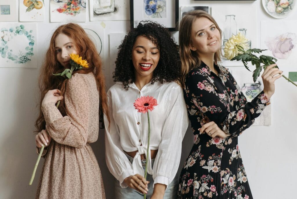 Three Women Holding Flowers