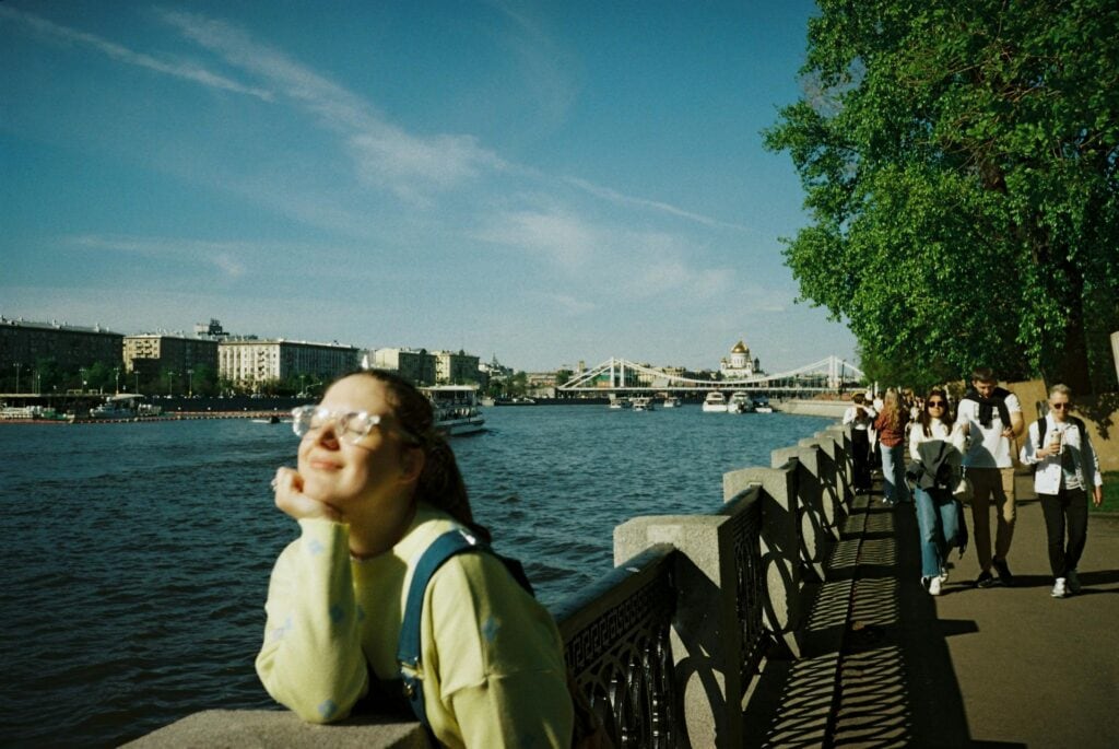 Girl enjoying the sun by the river