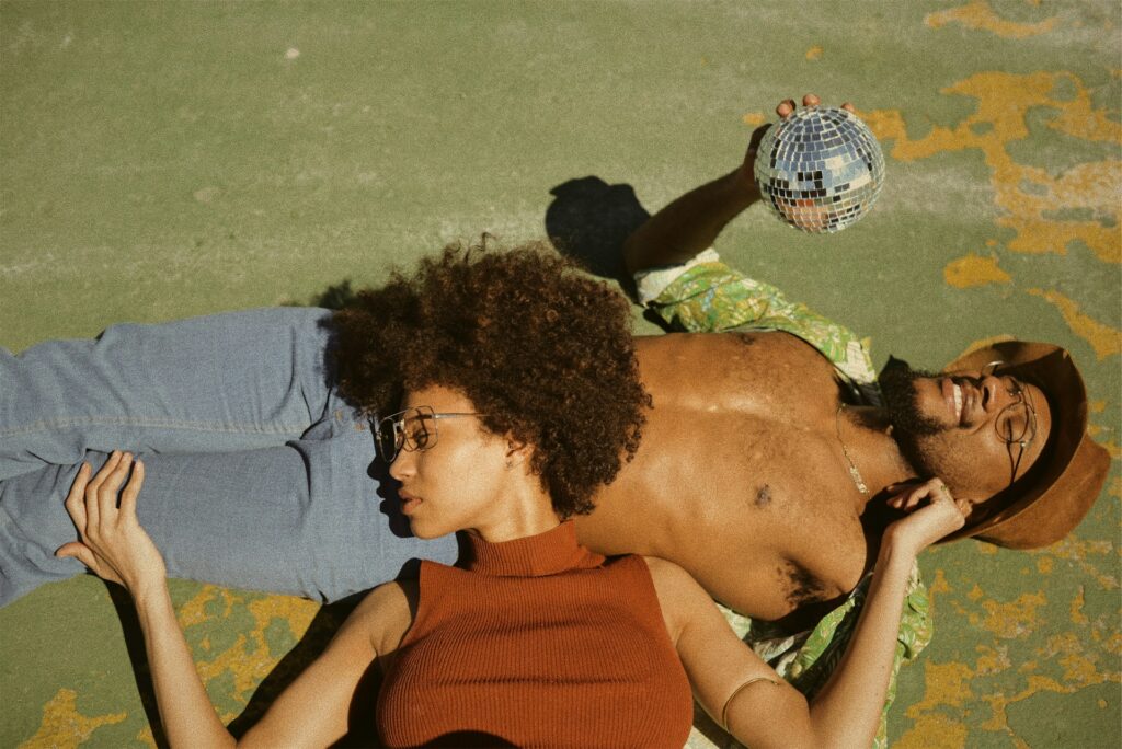 A man and a woman striking a pose on the floor.