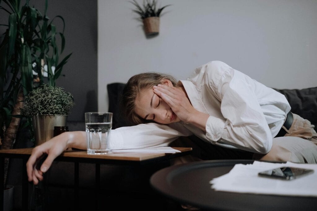 Lack of motivation causes: a woman burnt out by work.