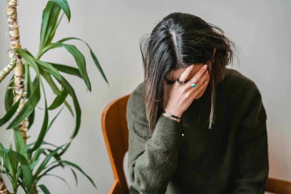 Tired woman with hand for face - Signs Your Needs Aren't Being Met & How To Recognize Them