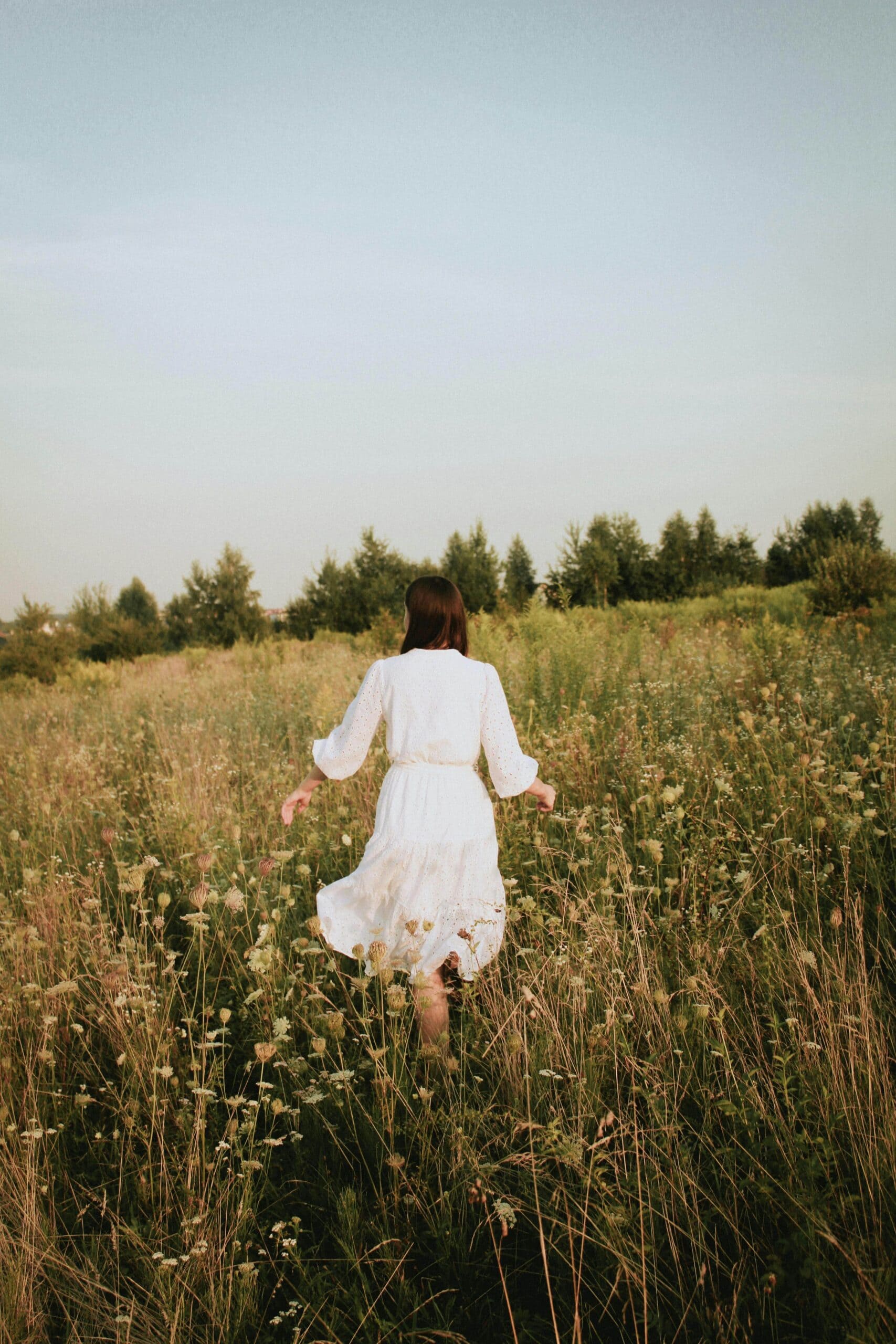 Woman in flower field - Signs Your Needs Aren't Being Met & How To Recognize Them