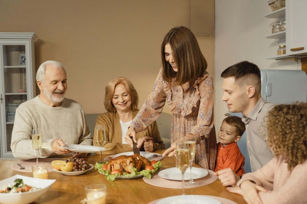 Happy family eating dinner together - How Do You Set Boundaries With In-Laws? 11 Tips That'll Help