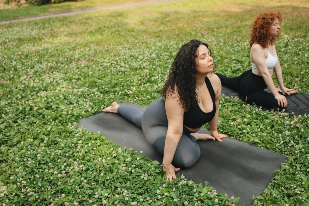 How To Get My Life Together: 10 Essential Tips For Powerful Change - image of Two women doing yoga on the grass.