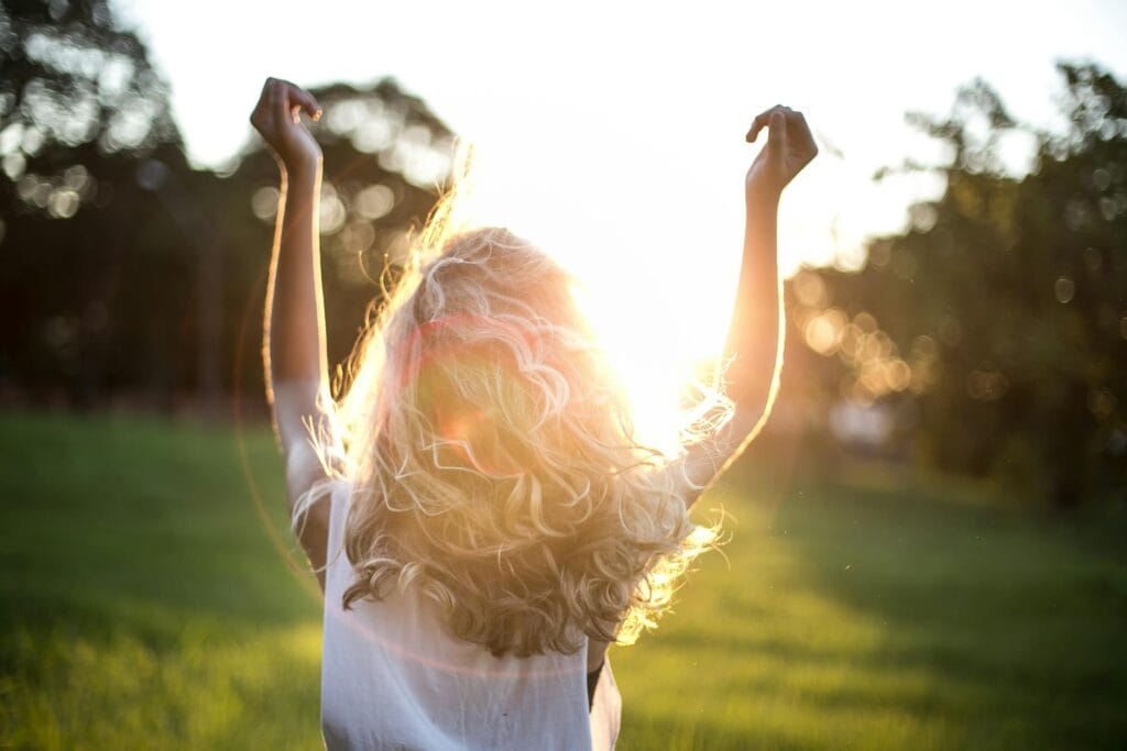 A woman facing the sunset.