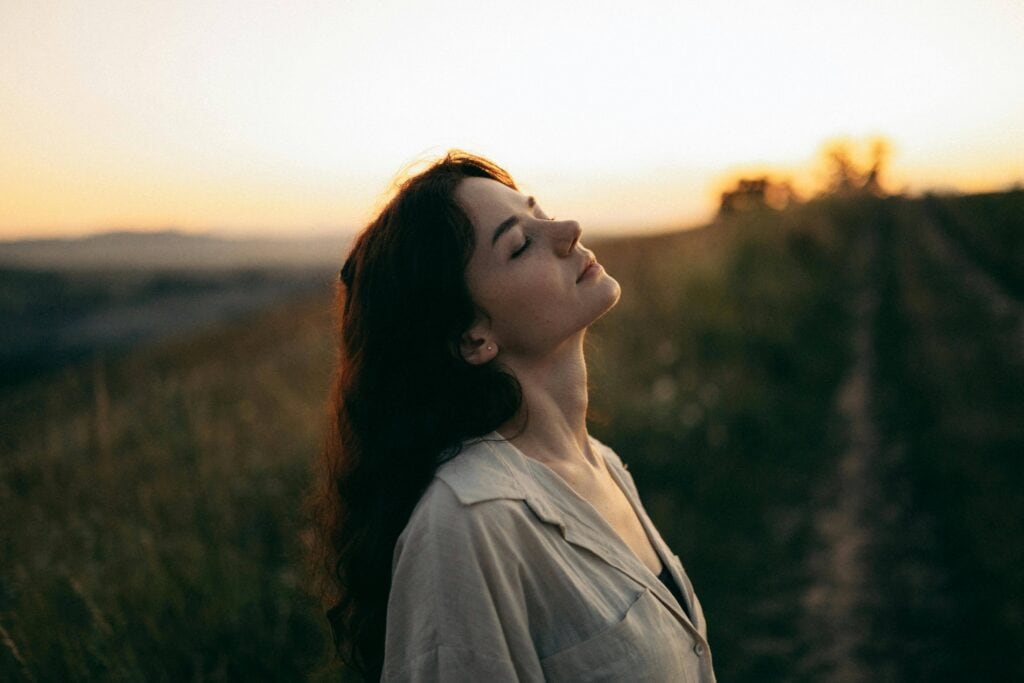 Woman with her eyes closed, visualizing her dreams - The Law Of Attraction Could Be Your Way To Success In Life