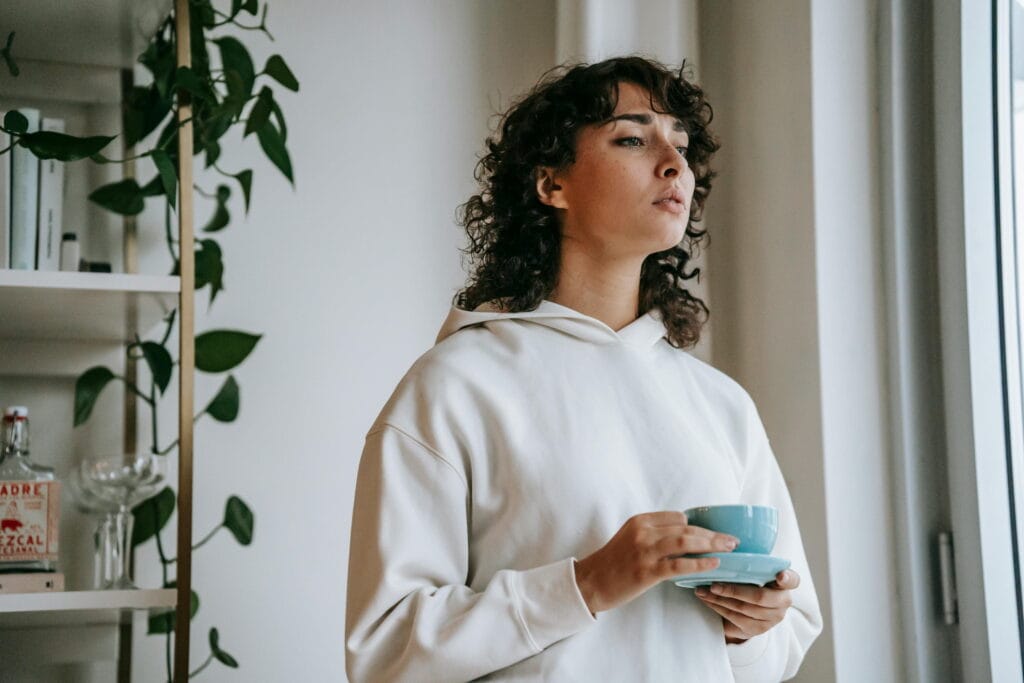 Woman thinking with coffee in her hands - What Is Visualizing? Learn Helpful Visualization Techniques