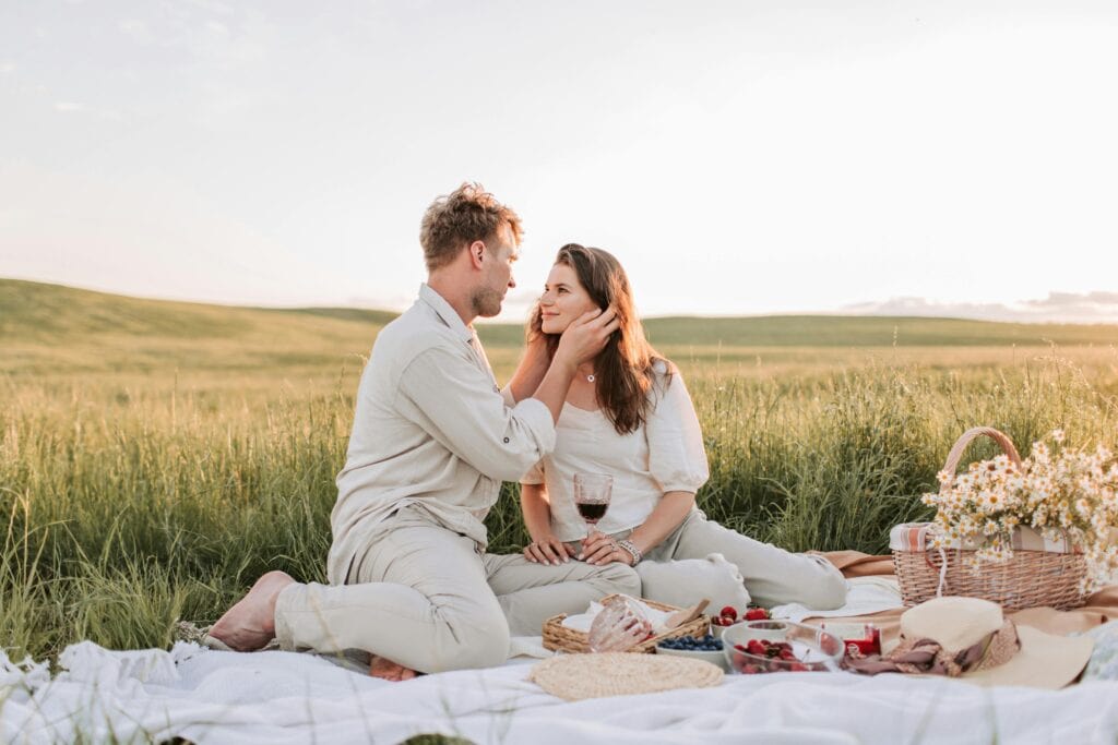 Couple that's in love having a romantic picnic - How To Communicate Your Needs In A Relationship Effectively