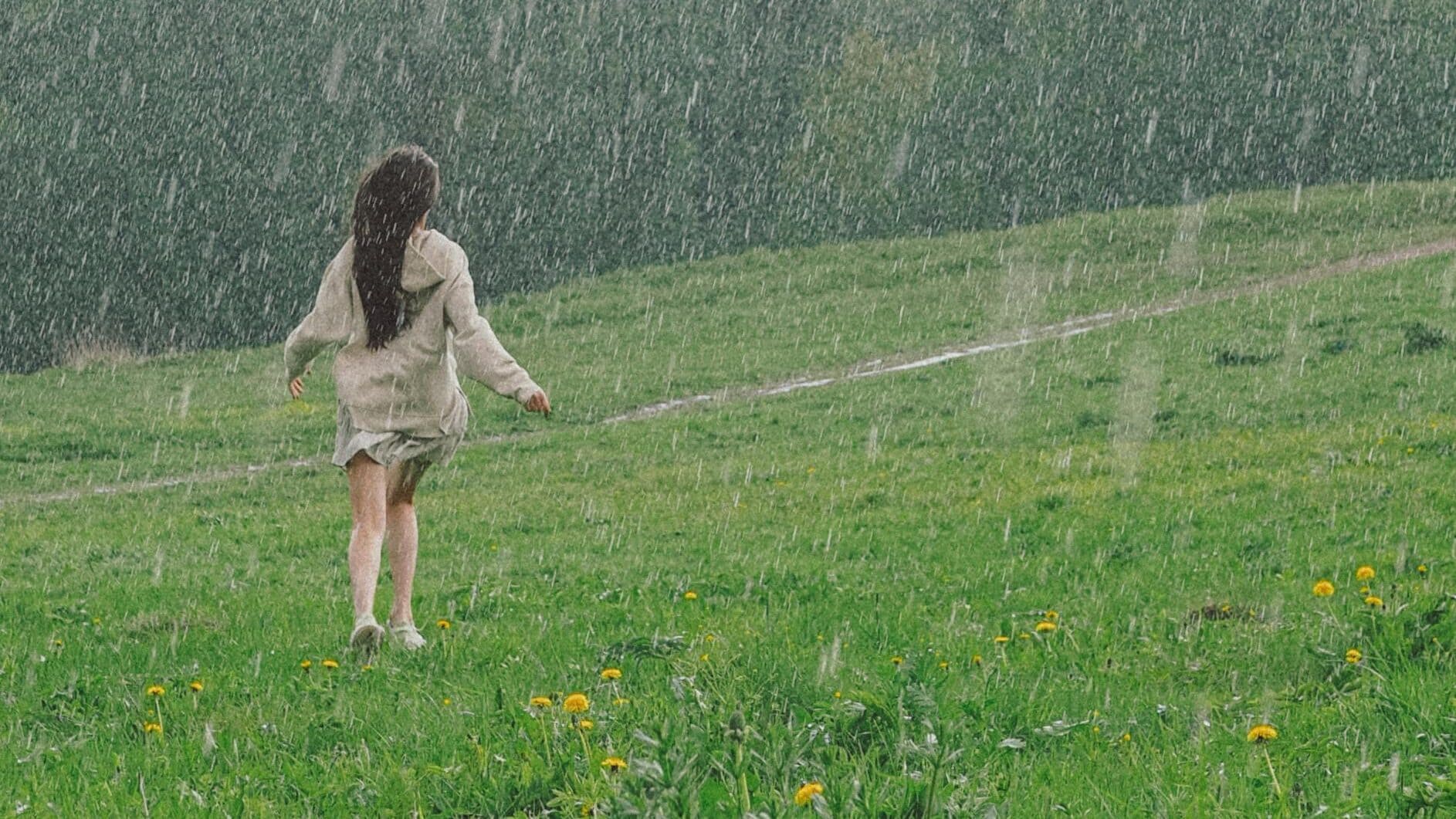 Woman running in rain - Divine Feminine Energy: How To Embrace Its Power