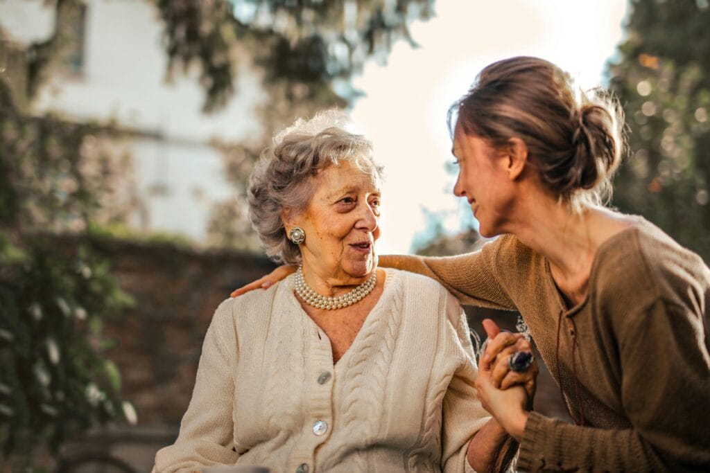 Woman caring for elderly woman - Divine Feminine Energy: How To Embrace Its Power