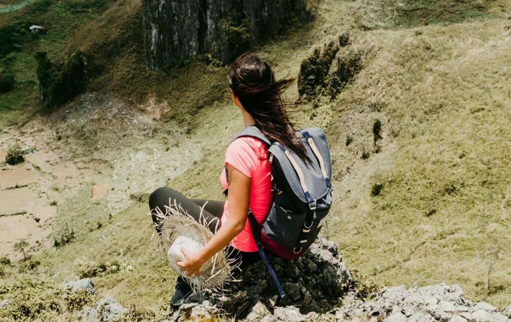 Woman on a mountain - 100 Things To Let Go Of For A Happier & Peaceful Life