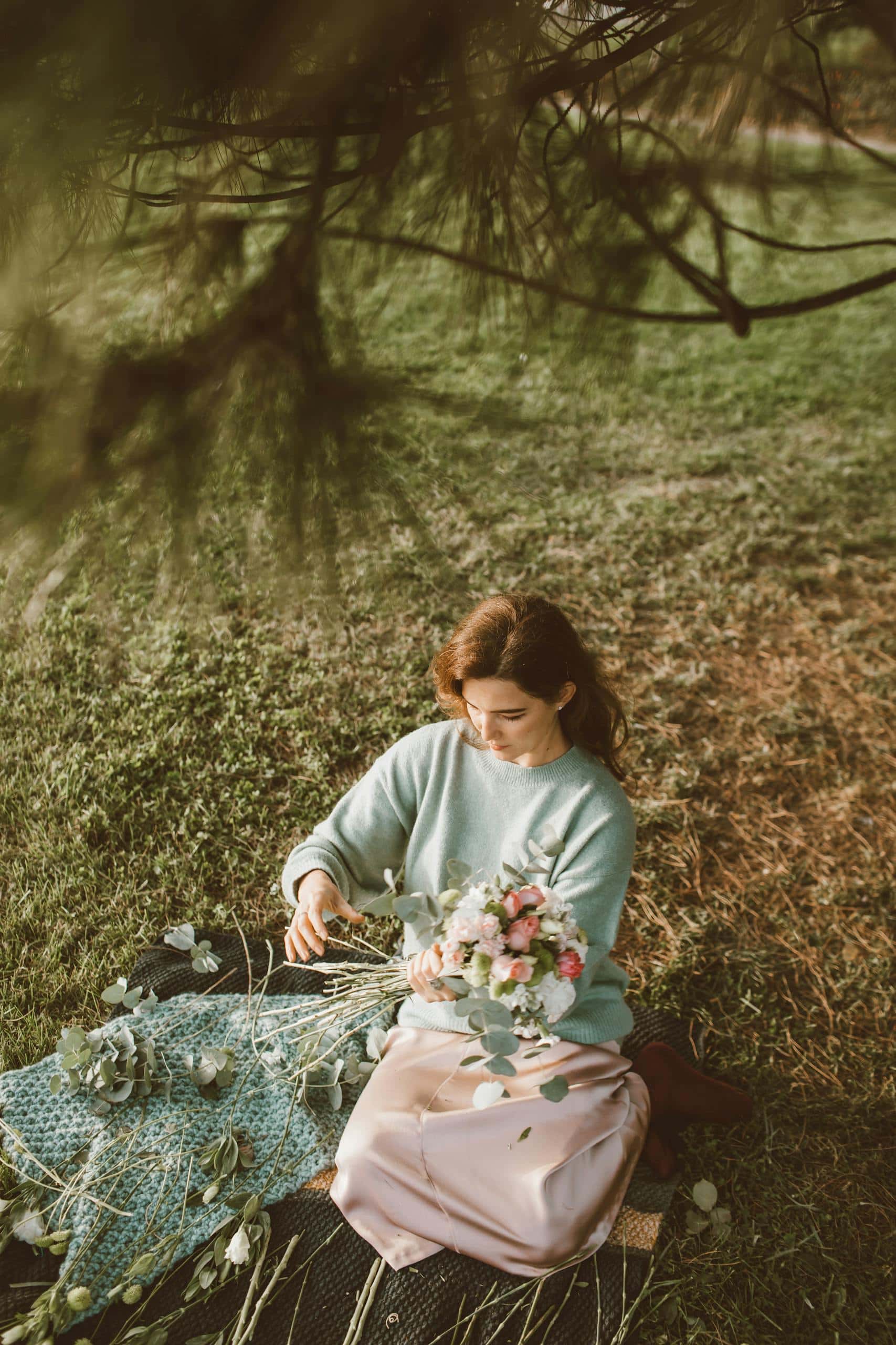 A woman in a serene garden setting arranging a beautiful bouquet of flowers with gentle pastel colors. - How To Heal Emotional Wounds: Practical Steps To Feel Relief